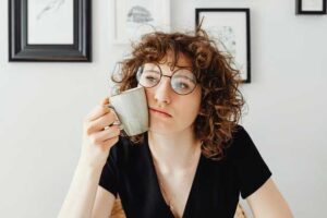 Indecisive woman drinking coffee